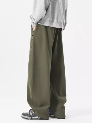 Men's relaxed fit army green sweatpants with drawstring and diagonal seam detail.