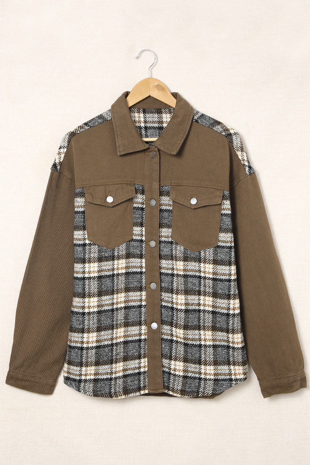 Olive mixed media shacket with plaid front and solid sleeves, featuring a collared neckline and chest pockets.