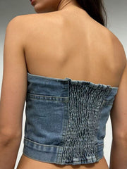 Structured denim tube top with smocked back detail and button accents, casual chic style.