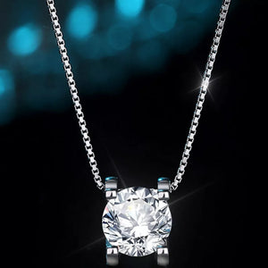 Dazzling Moissanite pendant necklace in silver with a round-cut stone on a box chain.