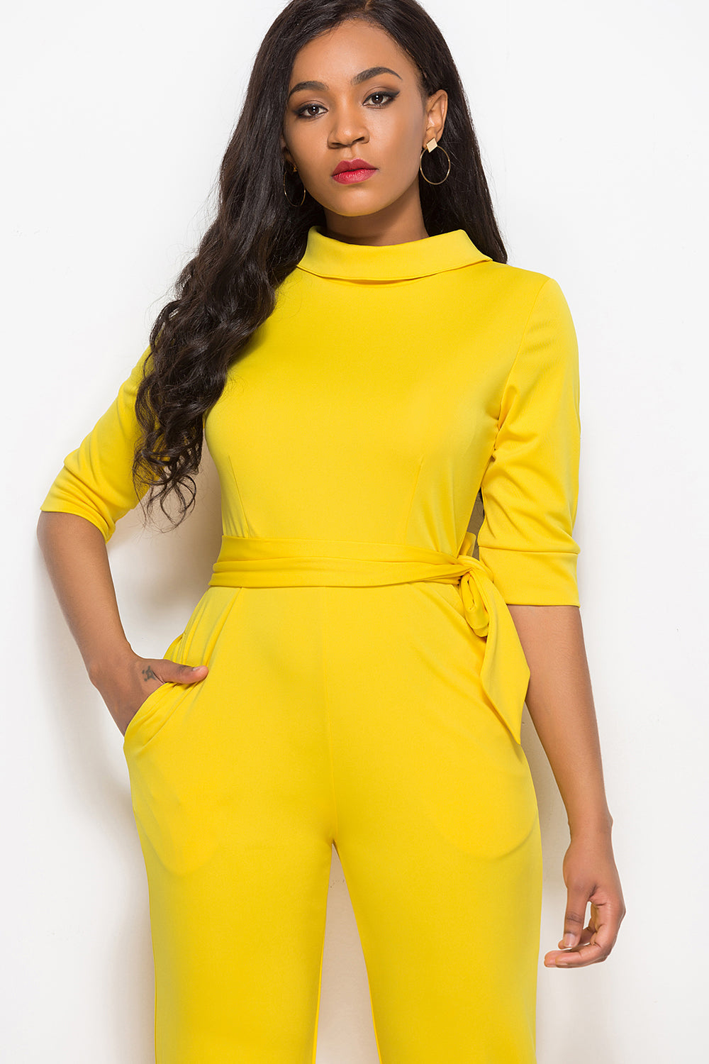 Yellow high-neck belted palazzo jumpsuit with 3/4 sleeves and pockets.