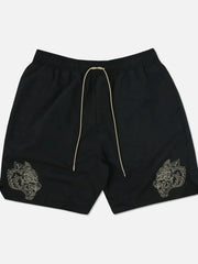 Black performance shorts with embroidered wolf heads and a drawstring waist.