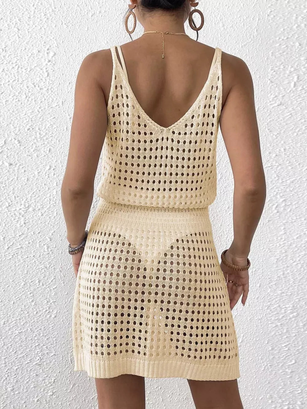 Beige openwork V-neck knit cover-up dress with spaghetti straps and a mini skirt.