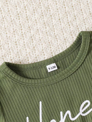 Green ribbed baby set with white script text and a size tag.