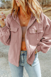Blush pink textured utility hoodie jacket with two chest pockets and a zip front.
