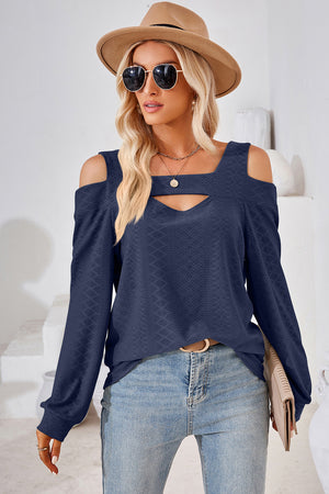 Dark blue geometric cutout shoulder top with a keyhole neckline and long sleeves.