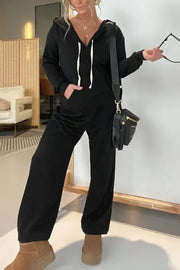 Black hooded jumpsuit with white drawstring and wide legs, casual loungewear.