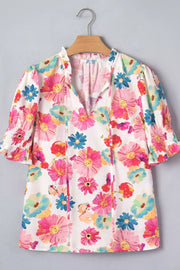 Vibrant floral print cotton blend shirt with ruched sleeves and tie-neck detail.