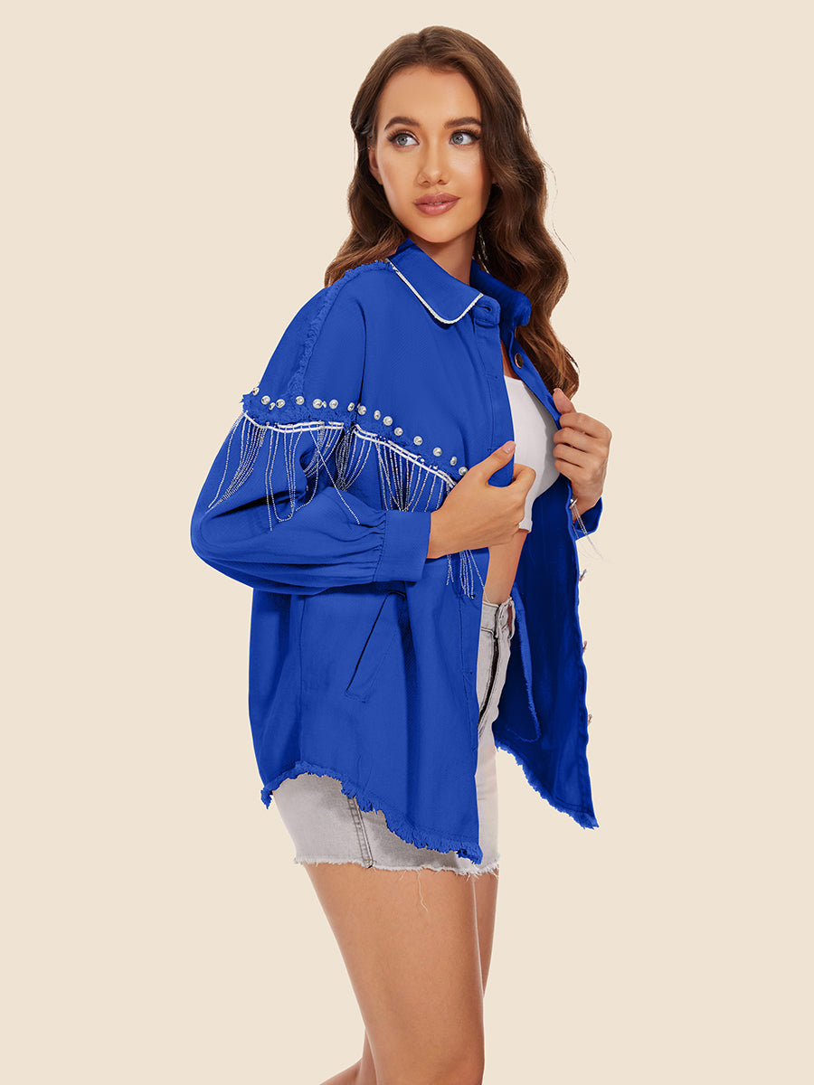 Royal blue denim trucker jacket with fringe and pearl embellishments on sleeves and chest.