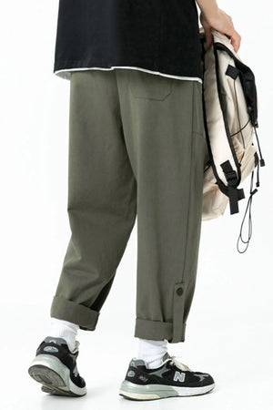 Relaxed fit cuffed cargo trousers in Army Green with button details and a casual cut.