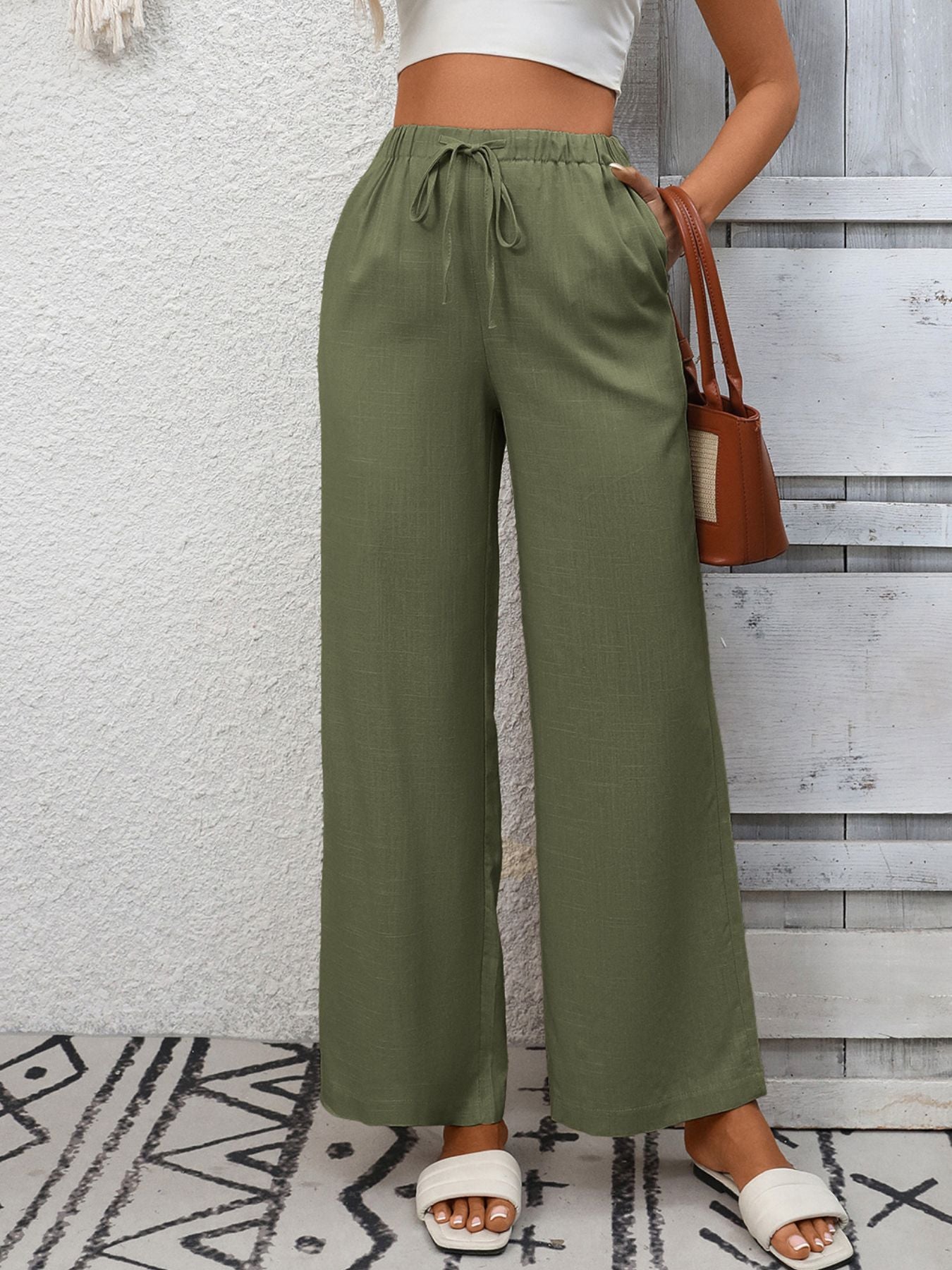 Army green high-waist wide-leg pants with drawstring and pockets.