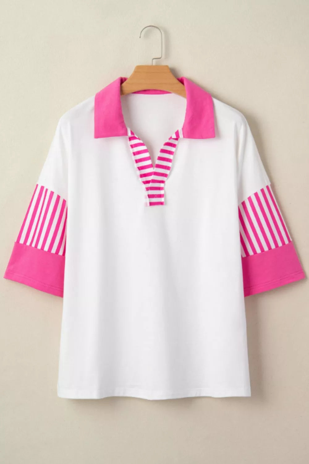 White polyester polo shirt with pink collar, striped placket, and striped sleeve panels.