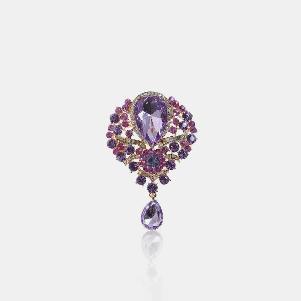 Regal teardrop embellished brooch with purple and pink crystals on alloy.