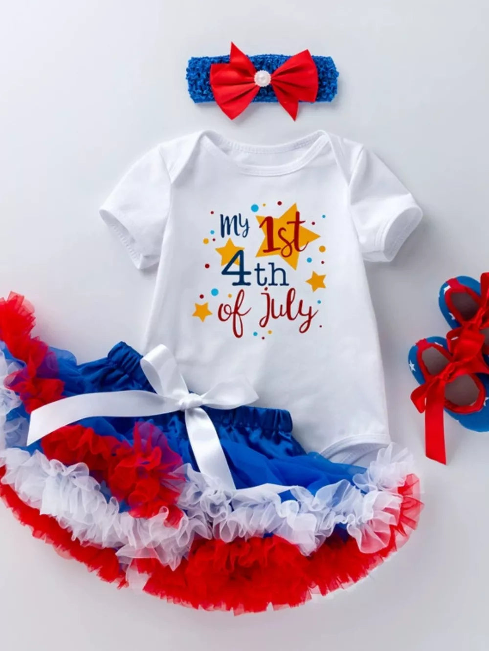 Baby outfit set with white bodysuit saying "my 1st 4th of July" and red, white, blue ruffled skirt.