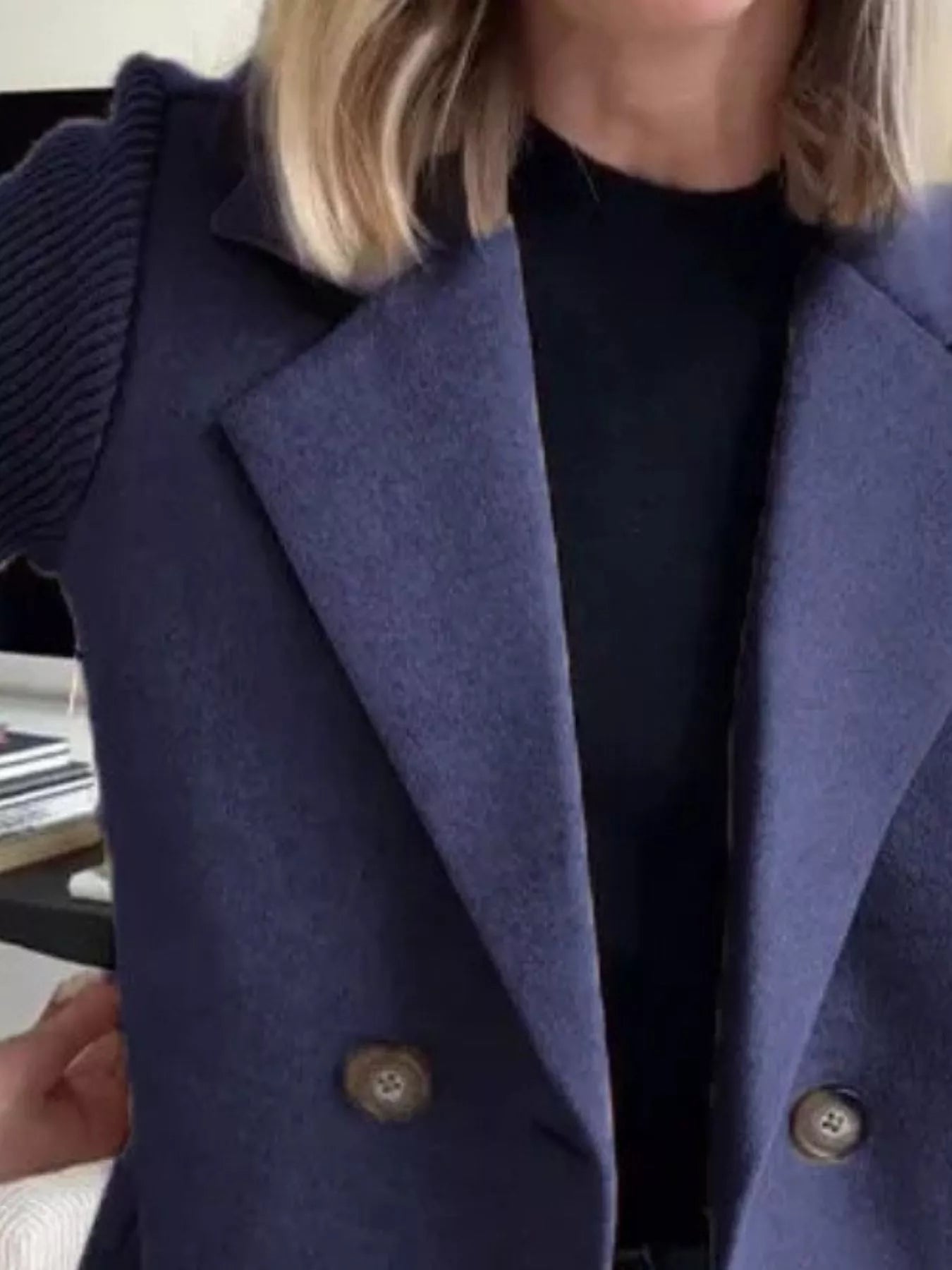 Dark blue double-breasted trench coat with knit sleeves and button detail