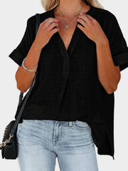 Black linen blend blouse with gathered yoke, V-neck, and cuffed short sleeves.