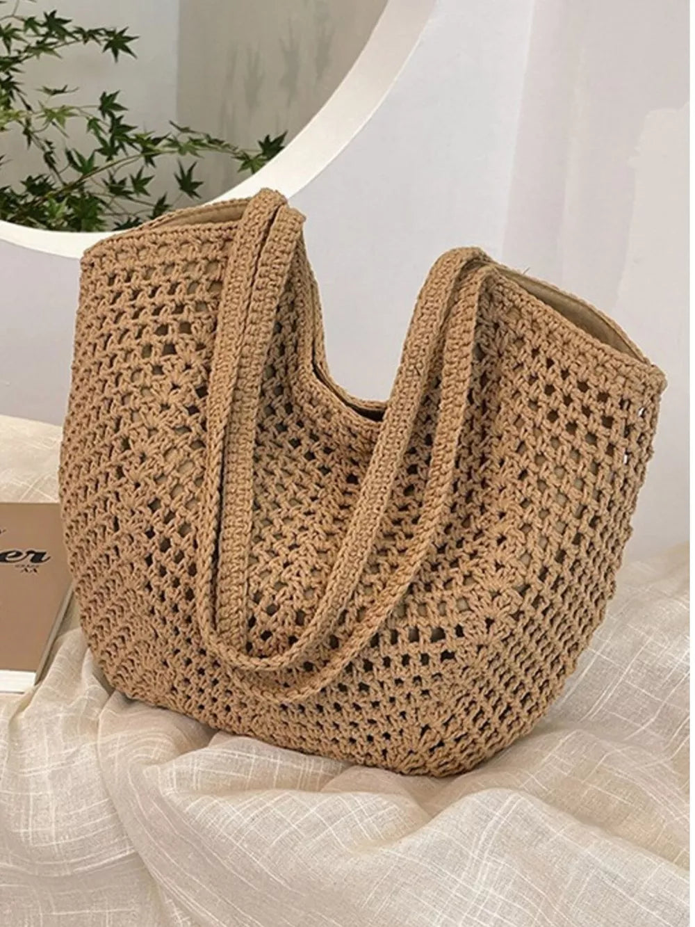 Chevron woven straw shoulder bag in Khakis with braided straps and open weave detail.