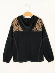 Black hoodie with leopard print shoulders and contrast stitching.