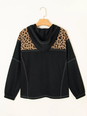 Black hoodie with leopard print shoulders and contrast stitching.