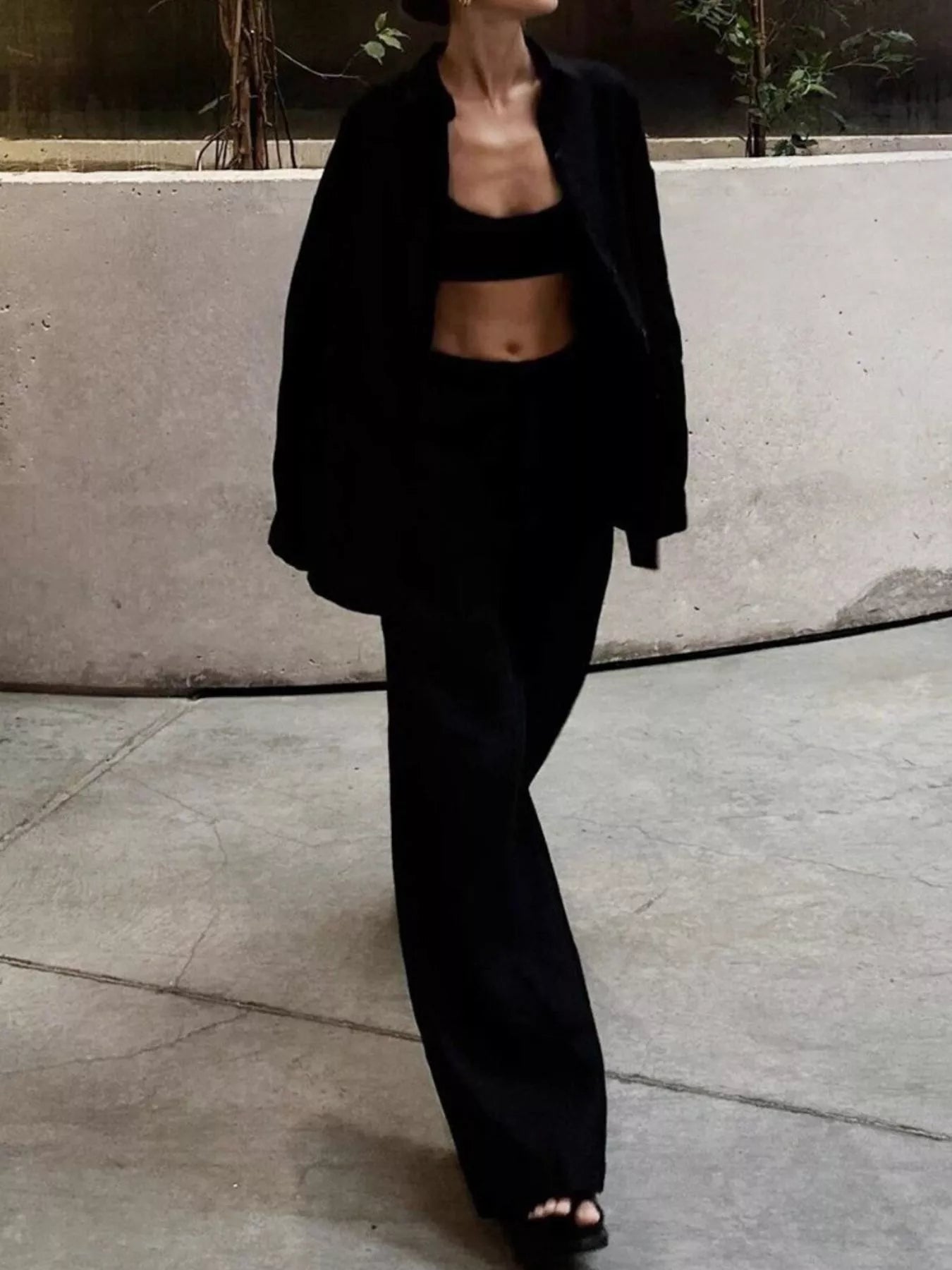 Black relaxed fit two-piece set with button-up shirt and wide-leg pants.