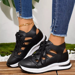 Chic black round toe lace-up sneakers with cut-out details and white soles.