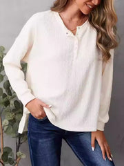 Ivory waffle knit henley with side slits and button detail.
