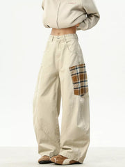 Men's beige cotton wide-leg sweatpants with plaid patchwork detail.