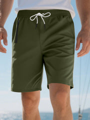 Men's military green chino shorts with drawstring waist and zip pocket detail.