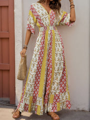 Bohemian print palazzo jumpsuit with V-neck, short sleeves, and ruffled hem in multicolor.