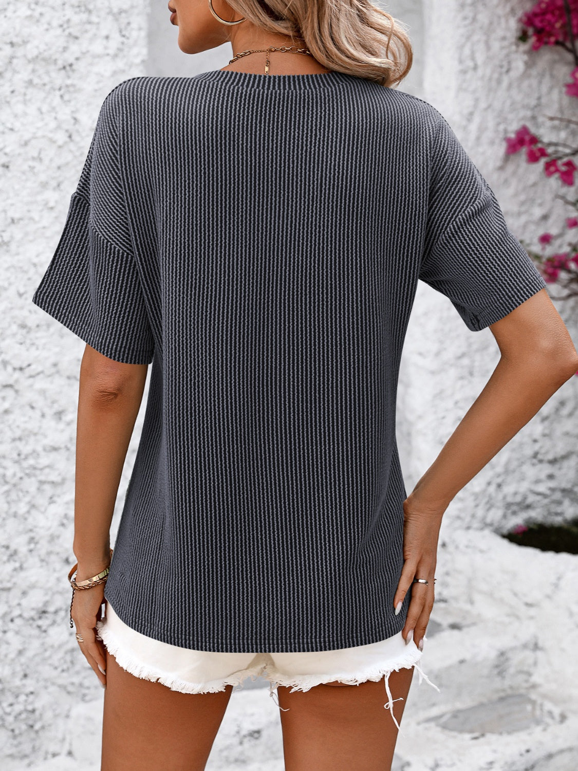 Textured ribbed charcoal v-neck tee with short sleeves and a pocket detail.