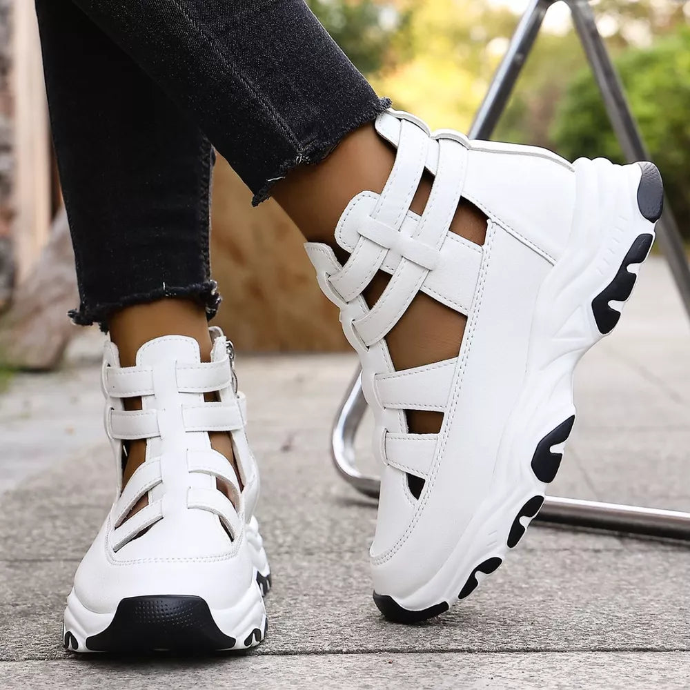 White chunky cutout platform sneakers with ankle straps and a zipper detail.