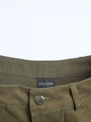 Olive green cotton cargo pants with button fly and visible brand tag.