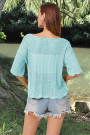 Aqua open-knit blouse with scalloped sleeves and boat neck, styled with denim shorts.