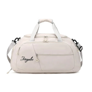 Pale Blush travel duffel bag with logo detail and multiple zippered pockets.