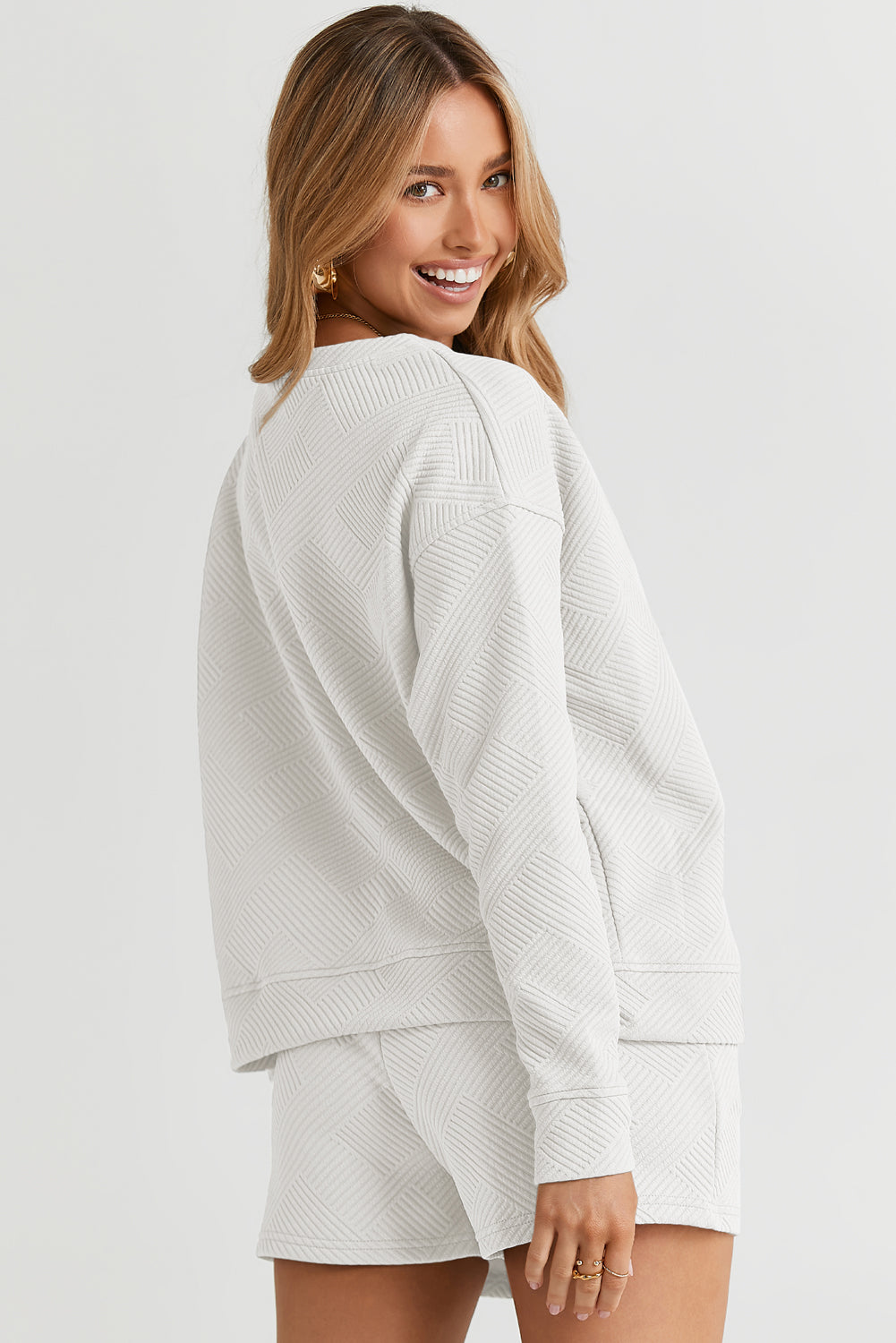Textured geometric loungewear set in white, featuring a crewneck sweatshirt and shorts.