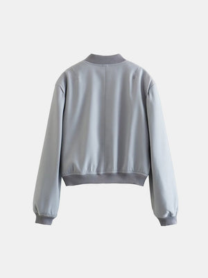 Boxy bomber jacket in light blue with ribbed collar, cuffs, and hem.