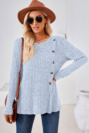 Light blue ribbed knit sweater with asymmetric button detail and crew neck.