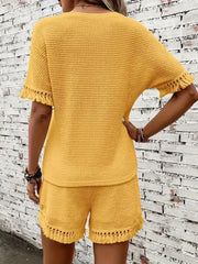 Textured knit set in gold with fringe trim on short sleeves and hem.