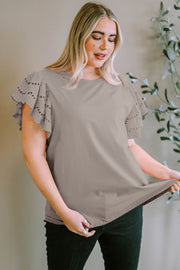 Eyelet flutter sleeve tee in mocha with a crew neck and short sleeves.