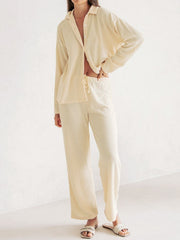 Cream ribbed knit lounge set with relaxed fit button-up shirt and drawstring pants.