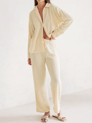 Cream ribbed knit lounge set with relaxed fit button-up shirt and drawstring pants.