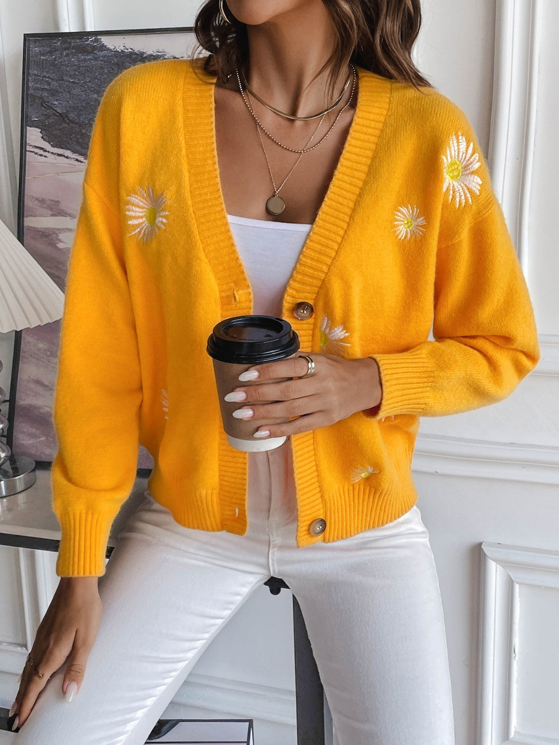 Gold button-down cardigan with embroidered daisies and ribbed trim.