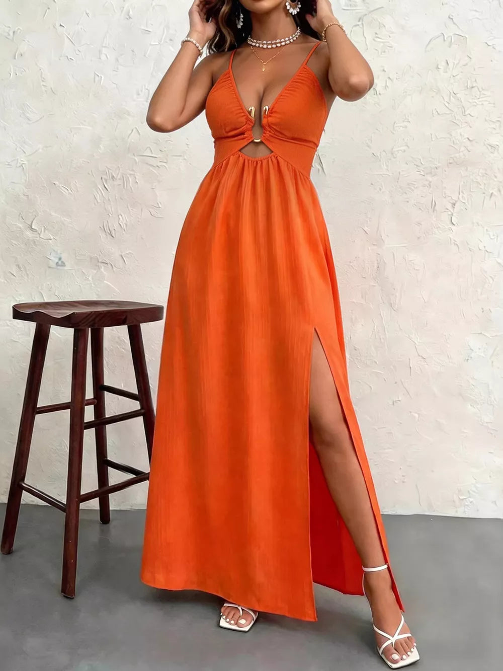 Orange maxi dress with plunging neckline, cutout detail, and high slit.
