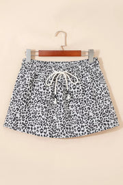 Leopard print denim skort in black and white with drawstring waist and pockets.