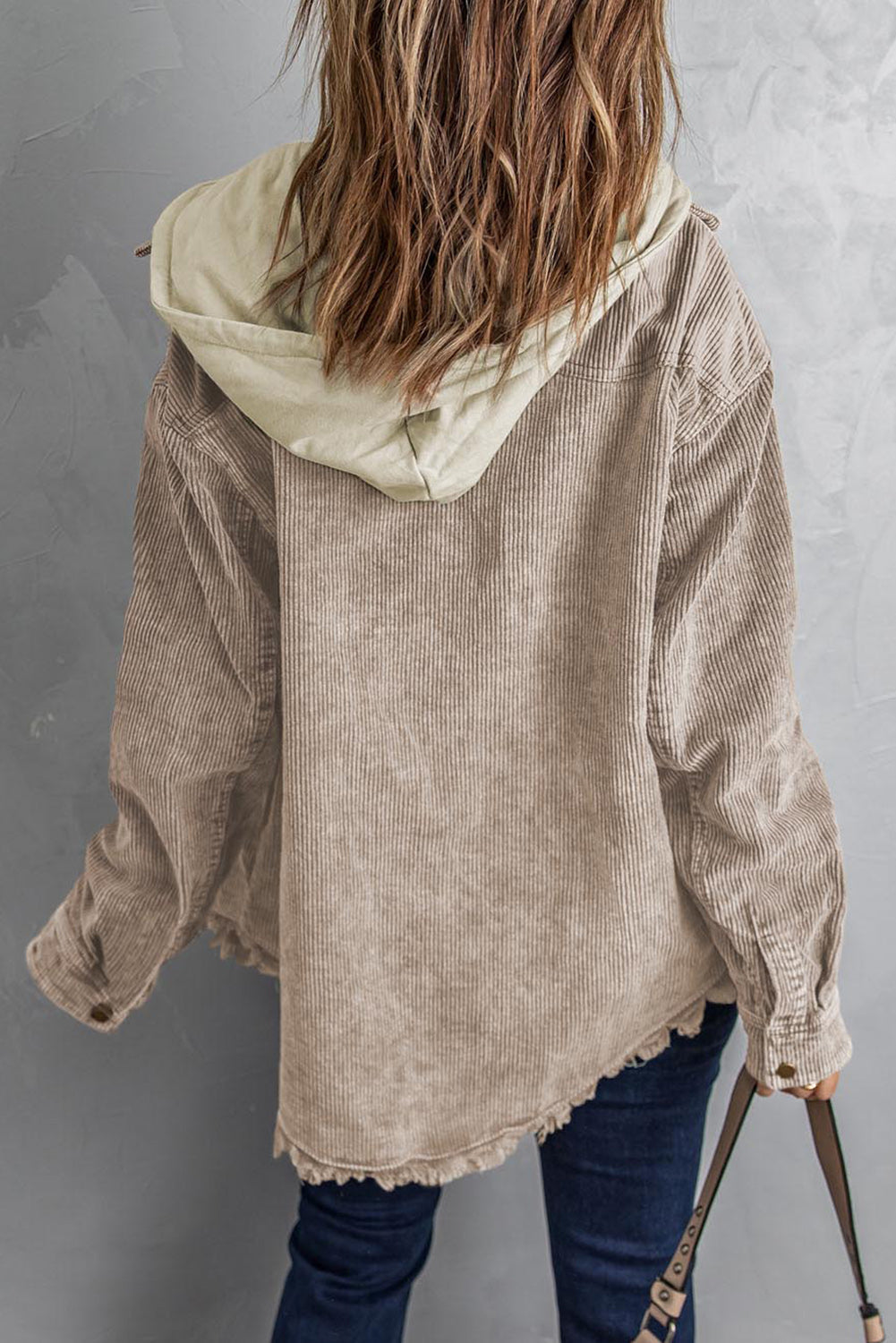 Tan corduroy hooded utility jacket with frayed hem and contrast hood.