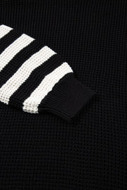Black knit turtleneck sweater with white stripe sleeves