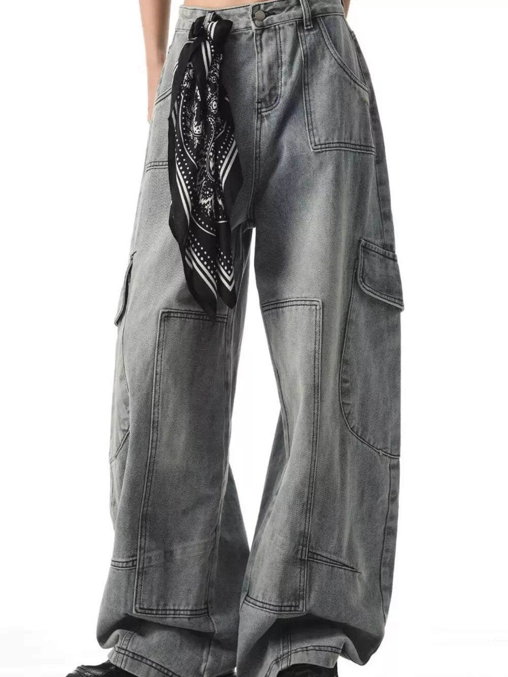 Relaxed fit grey cargo jeans with spacious pockets and a black bandana tied at the waist.