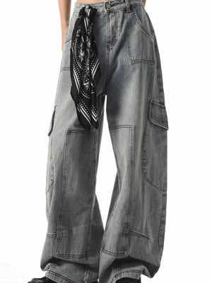 Relaxed fit grey cargo jeans with spacious pockets and a black bandana tied at the waist.