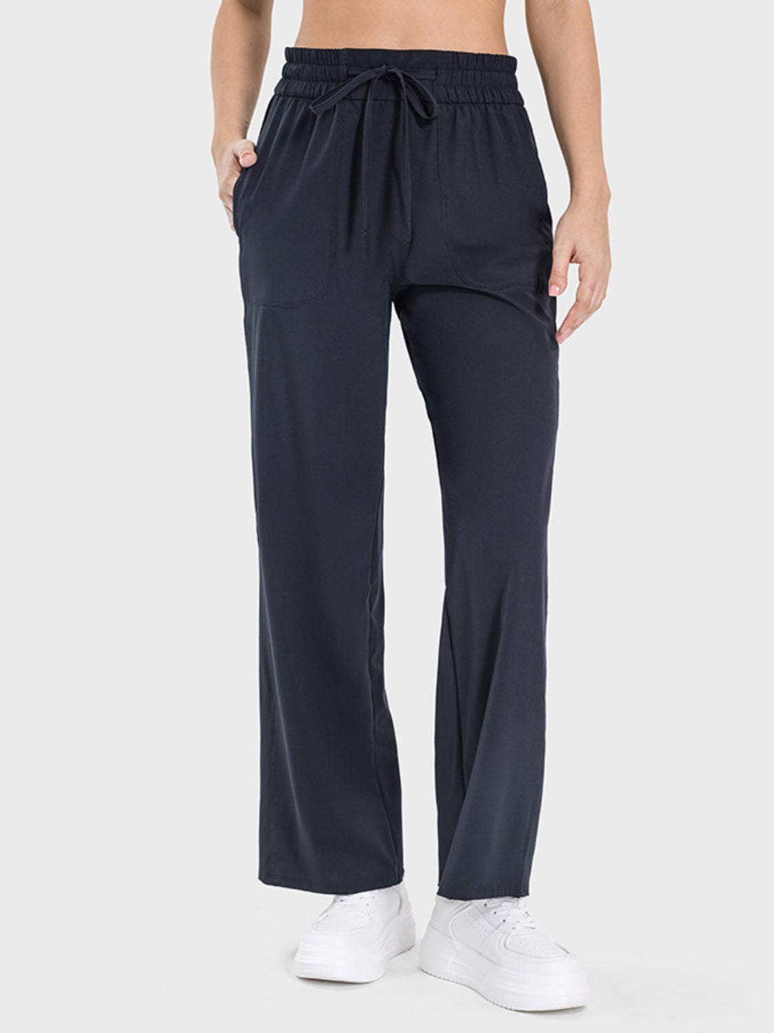Black relaxed drape drawstring palazzo pants with pockets and wide leg.