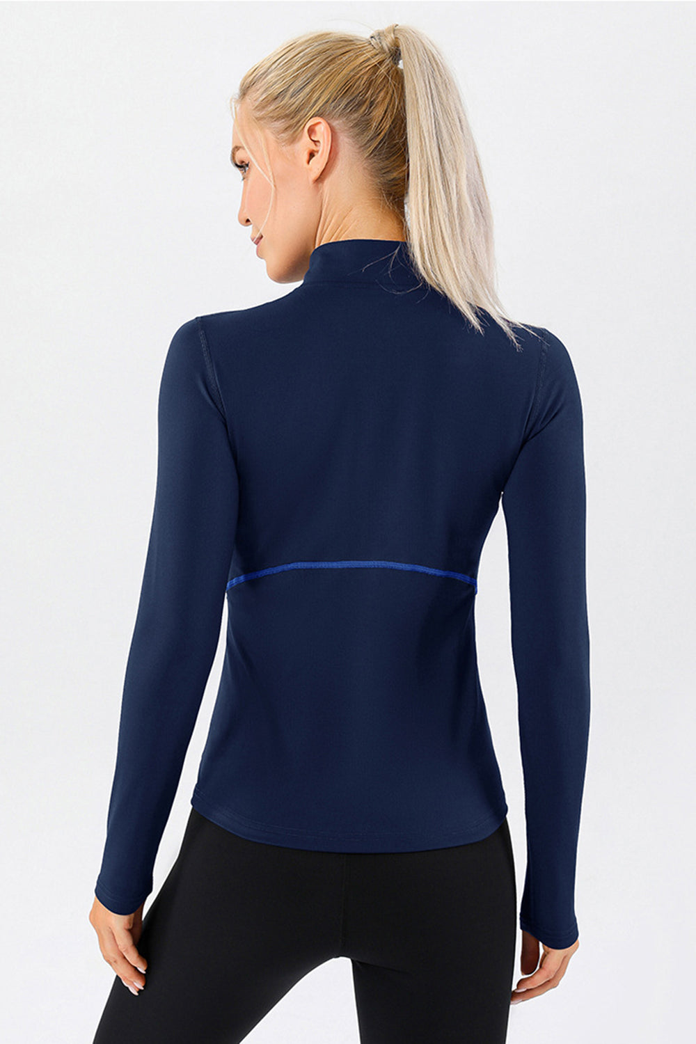 Dark blue athleisure zip-neck top with contrast seam detail and long sleeves.